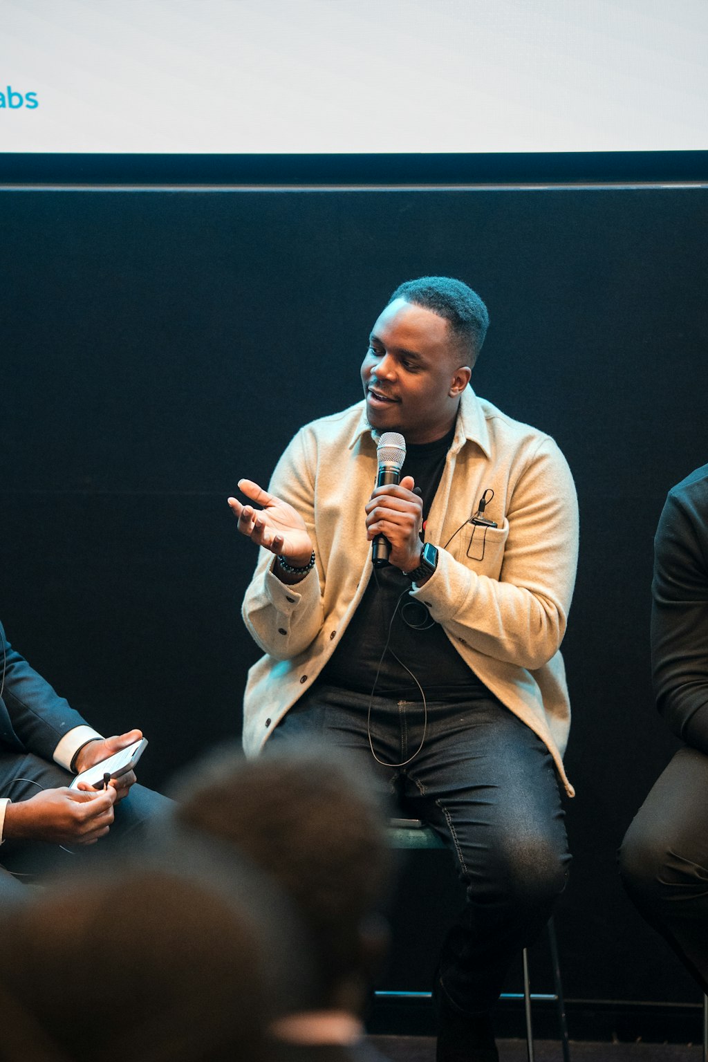 James Otemolu speaking into a microphone at an Eagle Labs panel