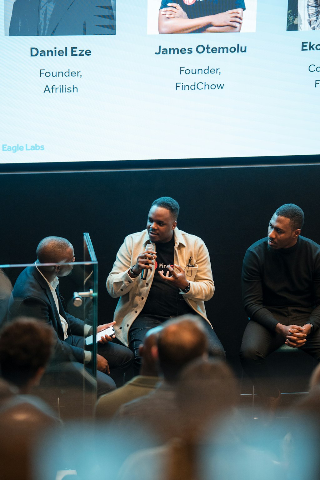 James Otemolu speaking at Eagle Labs, introduced on screen as Founder of FindChow