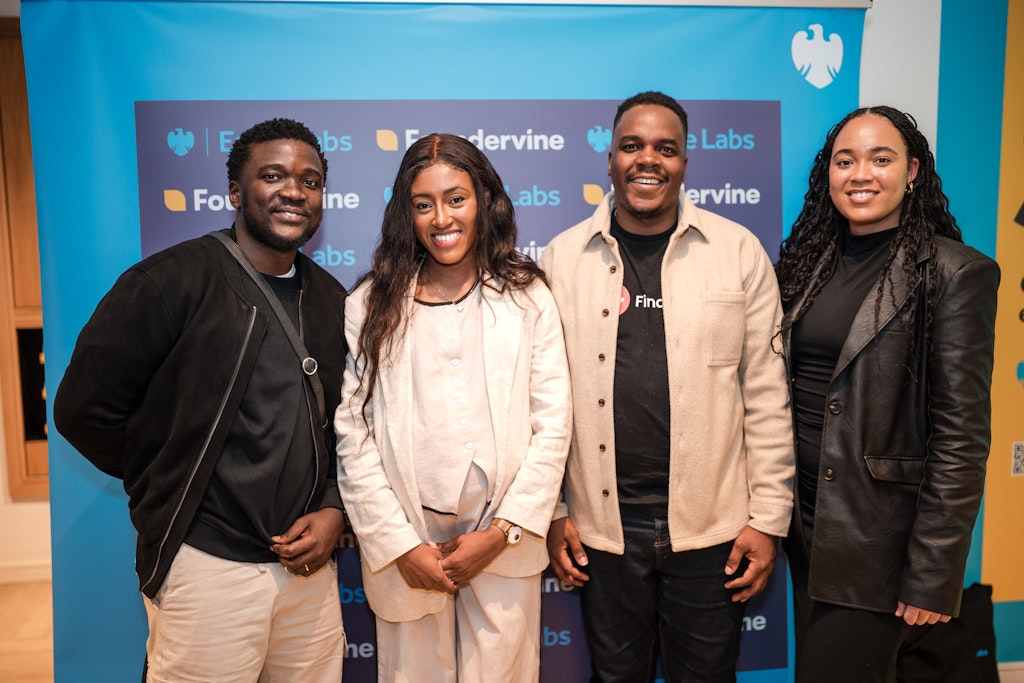 James Otemolu with guests in front of the Eagle Labs and Foundervine backdrop